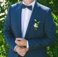 Young bridegroom in blue suit. outdoors