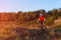 Young bright man on mountain bike riding in autumn landscape Royalty Free Stock Photo