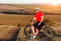 Young bright man on mountain bike riding in autumn landscape Royalty Free Stock Photo