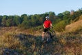 Young bright man on mountain bike riding in autumn landscape Royalty Free Stock Photo