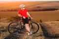 Young bright man on mountain bike riding in autumn landscape Royalty Free Stock Photo