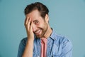 Young bristle man wearing shirt smiling and covering his face Royalty Free Stock Photo