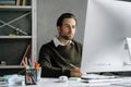 Young man working with computer at desk in office Royalty Free Stock Photo