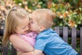Young Brother Kisses Sister on the Cheek At The Park Royalty Free Stock Photo