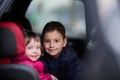 A young brother and sister enjoying a car ride together, immersed in the adventure of travel Royalty Free Stock Photo