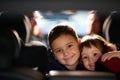 A young brother and sister enjoying a car ride together, immersed in the adventure of travel Royalty Free Stock Photo