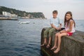 A young brother and sister fishing in the sea with Royalty Free Stock Photo