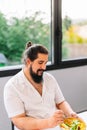 young man takes a salad break while working at home Royalty Free Stock Photo