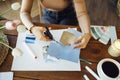 Young brunette african american woman creating her Feng Shui wish map using scissors Royalty Free Stock Photo