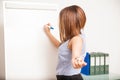 Young brunette asking a question to her class Royalty Free Stock Photo