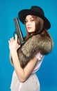 A young brunette in a black hat with a gun in his hand Royalty Free Stock Photo