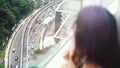 Young brunette blurred woman looking through the window on focused urban city view with buildings and roads. Royalty Free Stock Photo