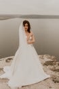 bride woman with short haircut in white wedding corset dress strapless and with a long chiffon veil on head Royalty Free Stock Photo