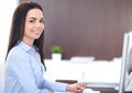 Young brunette business woman looks like a student girl working in office. Hispanic or latin american girl happy at work Royalty Free Stock Photo