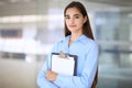 Young brunette businesswoman or student girl looking at camera