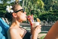 Young brunette cheerful woman suntanning near hotel swimming pool Royalty Free Stock Photo