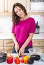 Young brunette cooking vegetables at home