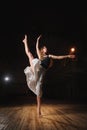 Young brunette dancer girl in split jump