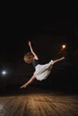 Young brunette dancer girl in split jump