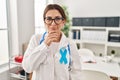 Young brunette doctor woman wearing stethoscope at the clinic looking confident at the camera with smile with crossed arms and Royalty Free Stock Photo