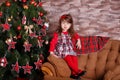 Young brunette dolly lady girl stylish dressed in red dress costume chequers check tartan skirt strap shoes smiling posing sitting Royalty Free Stock Photo