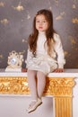 Young brunette dolly lady girl stylish dressed in white skirt midi petticoat and waist blouse smiling posing in studio close to ch