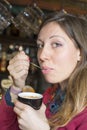 Young brunette drinking coffee at a coffee shop Royalty Free Stock Photo