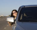 Young brunette driving silver car Royalty Free Stock Photo