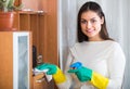 Young brunette dusting at home Royalty Free Stock Photo