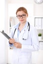 Young brunette female doctor at work in hospital. Physician ready to help. Medicine and healthcare concept Royalty Free Stock Photo