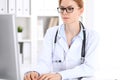 Young brunette female doctor at work in hospital. Physician ready to help. Medicine and healthcare concept Royalty Free Stock Photo