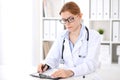 Young brunette female doctor at work in hospital. Physician ready to help. Medicine and healthcare concept Royalty Free Stock Photo