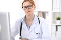 Young brunette female doctor at work in hospital. Physician ready to help. Medicine and healthcare concept Royalty Free Stock Photo