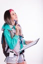 Young brunette female student standing and listening to music from your device. Royalty Free Stock Photo