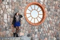 Young girl near the old stone wall Royalty Free Stock Photo