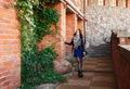 Young girl near the old stone wall Royalty Free Stock Photo