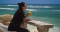 Girl drinking juice on the beach, Bali, Indonesia, 4k