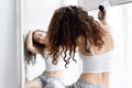 Daily routine. Young female drying her curly hair Royalty Free Stock Photo