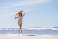 Young brunette girl walking graciously on the beach. Royalty Free Stock Photo