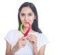 Young brunette girl holding red and green pepper chili isolated on white background Royalty Free Stock Photo