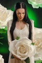 The young brunette girl with huge buds of white roses