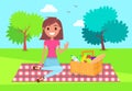 Young brunette girl at picnic in summer park, lady sitting at plaid with basket full of products