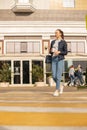 A girl walks through the central streets of the city drinking coffee Royalty Free Stock Photo