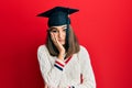 Young brunette girl wearing graduation cap thinking looking tired and bored with depression problems with crossed arms Royalty Free Stock Photo