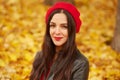 Young brunette happy smiling female wearing red beret and leather jacket, looking directly at camera, posing outdoor, lady having Royalty Free Stock Photo