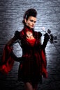 A young brunette lady vampire holding a rose Royalty Free Stock Photo