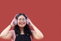 Young brunette Latina woman 17 years old with eye glasses and braces on her teeth enjoys listening to music on her headphones Royalty Free Stock Photo