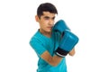 Young brunette man in blue boxing gloves practicing isolated on white background Royalty Free Stock Photo