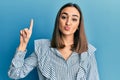 Young brunette student girl pointing up with finger looking at the camera blowing a kiss being lovely and sexy Royalty Free Stock Photo