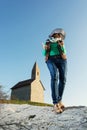 Young brunette in a stylish hat and an old romanesque church Arc Royalty Free Stock Photo